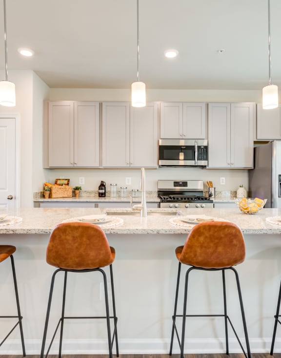 Kitchen with an Island and Brown Stools at Refinery Row in Baltimore, MD