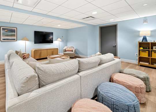 A living room with a grey couch and a flat screen TV.