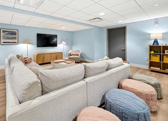 A living room with a grey couch and a flat screen TV.