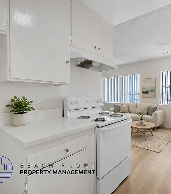 A well-lit, modern kitchen and living room with a dining area.