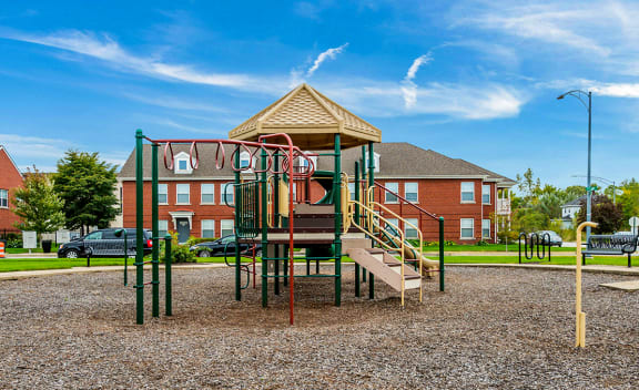 A green and beige playground at Horace Mann apartments and townhomes in Gary, IN