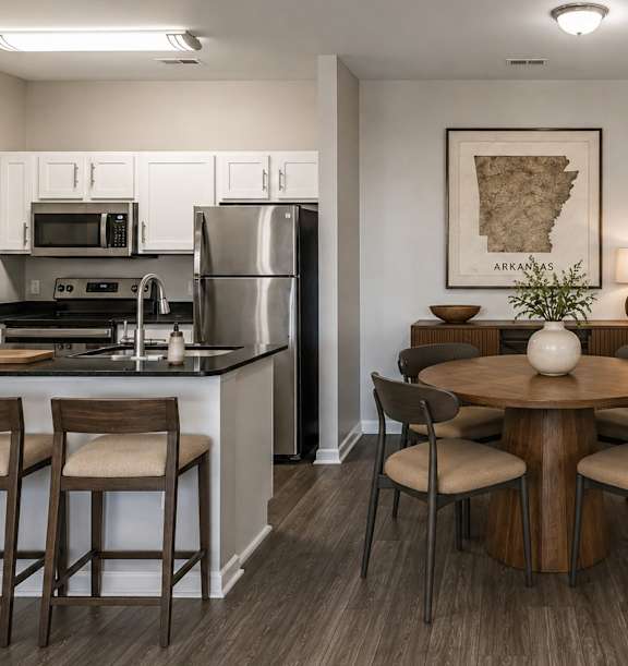 A kitchen with a table and chairs in the middle of the room.