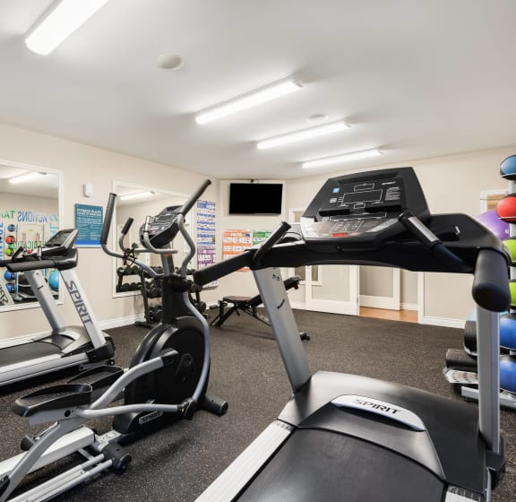 A gym with treadmills and exercise equipment. at Sage Apartments, Everett, 98204