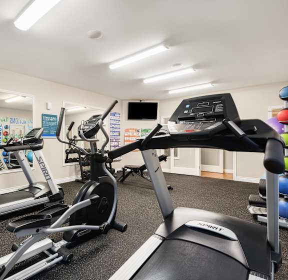 A gym with treadmills and exercise equipment. at Sage Apartments, Everett, 98204