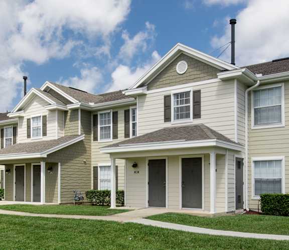 a row of houses on a grassy hill