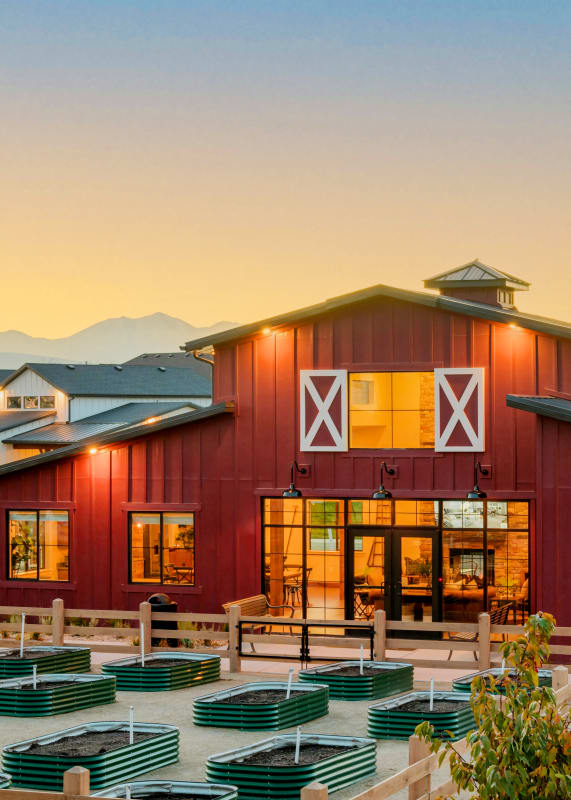 a red barn with an outdoor amphitheater at sunset