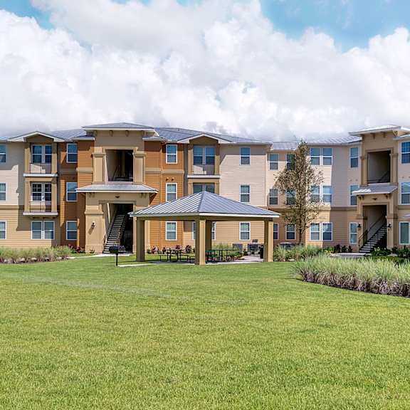 A large grassy area in front of apartment buildings.