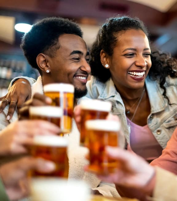 a group of people sitting at a table laughing and drinking beer at The Groves, Gastonia, NC, 28056