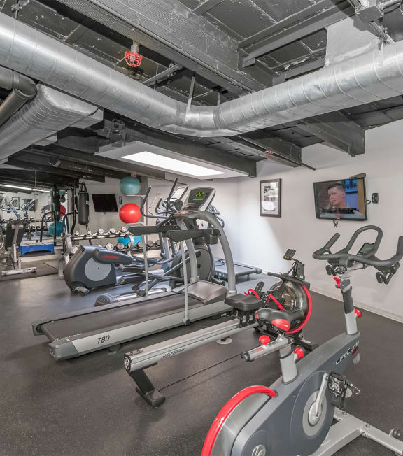 the gym at the district at highland village apartments