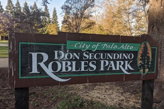 a sign in front of a tree