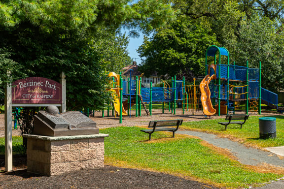 a park with a playground and a sign