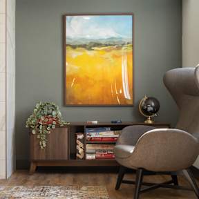 A living room with a fireplace, a painting, a chair, and a globe.