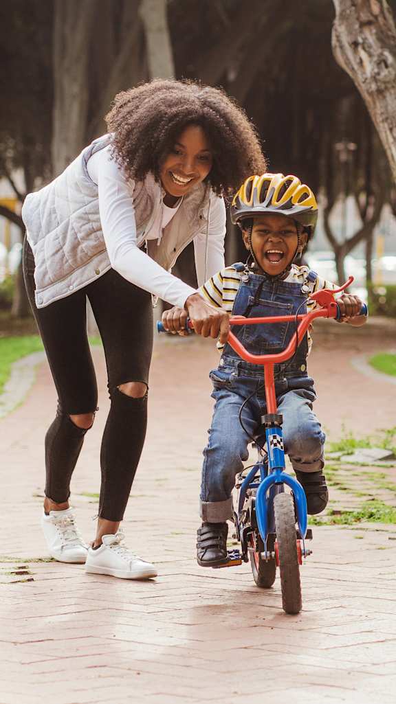 child riding cycle at The Village at Sun Valley Apartments, Mesa Arizona