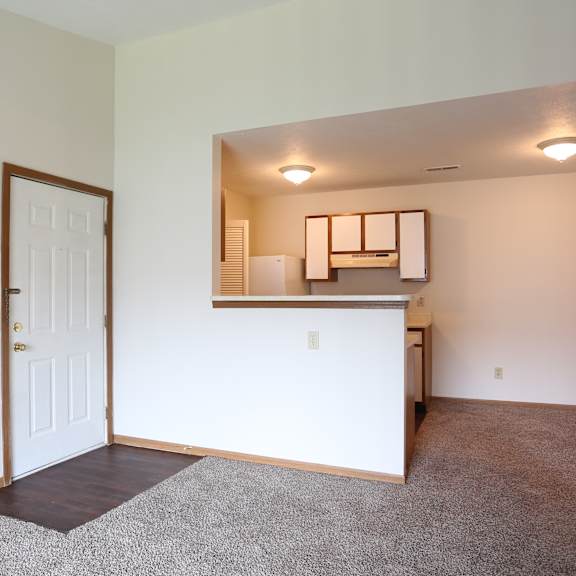 A room with a white door and a white cabinet.