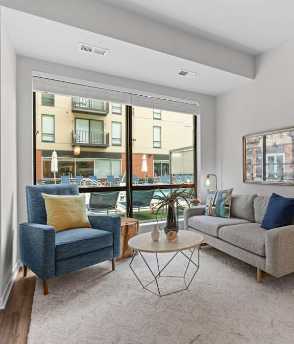 Inviting Living Room With Tall Ceilings & Lots Of Natural Light