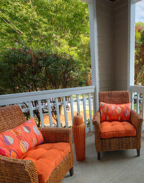 A patio with two chairs and a table.