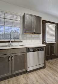 a kitchen with wooden cabinets and stainless steel appliances
