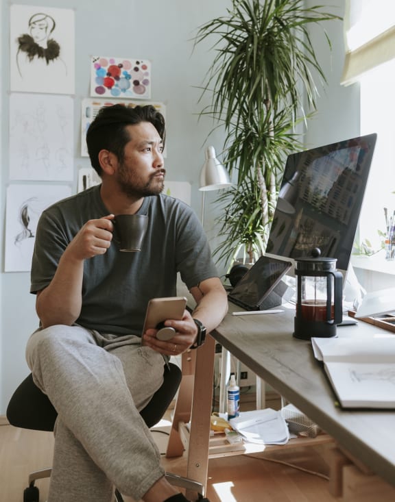 a man sitting at a desk in front of a computer