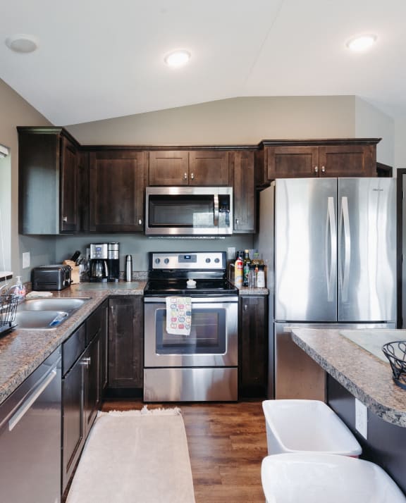 a kitchen with stainless steel appliances and wooden cabinets