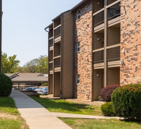 In front of a brick apartment building at Foxfire Apartments.