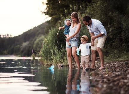 Young Family Fishing Together Smiling