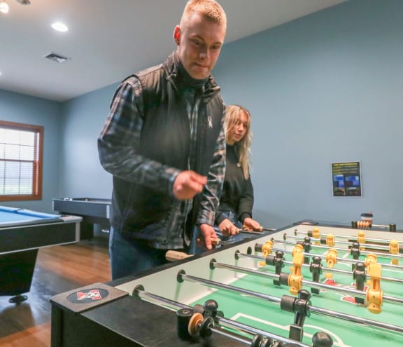 people playing a game of foosball on a table at Summit Ridge, Duluth, MN, 55811
