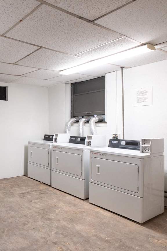 A laundry room with washers and dryers. at Mariposa Willows Apartments, Los Angeles