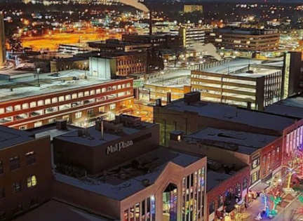 A cityscape at night with buildings and lights.