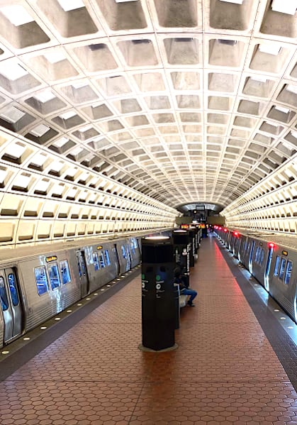 a subway station with a train parked on the tracks