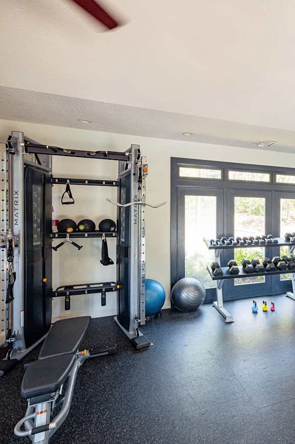 a gym with cardio equipment and weights at the gateway apartments at Inverness Cliffs, Birmingham, Alabama