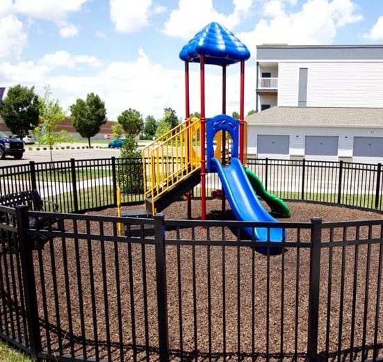 a playground in a yard with a slide