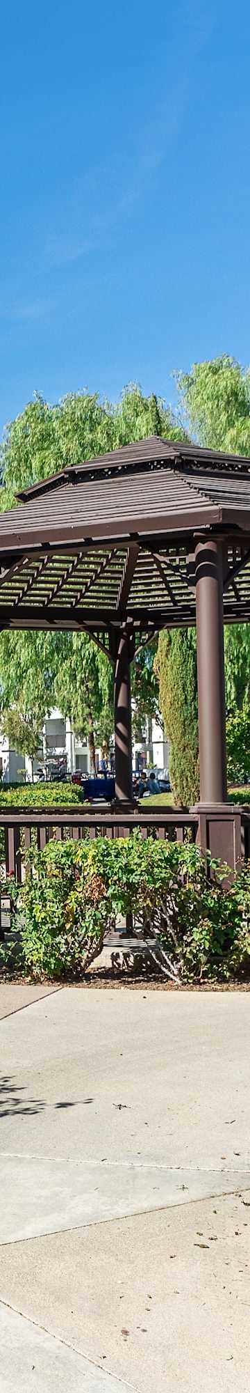 A gazebo is surrounded by greenery and trees in a residential area. at Barrington Place, Rancho Cucamonga, CA, 91739