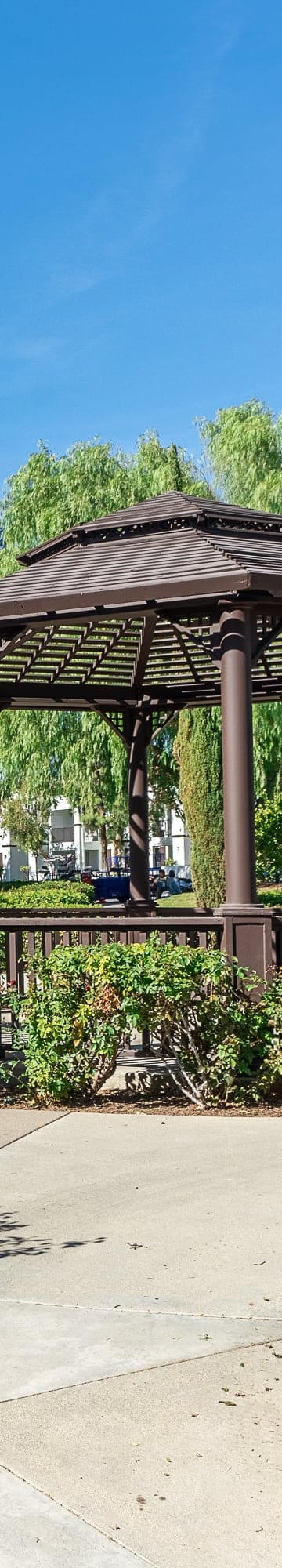 A gazebo is surrounded by greenery and trees in a residential area. at Barrington Place, Rancho Cucamonga, CA, 91739