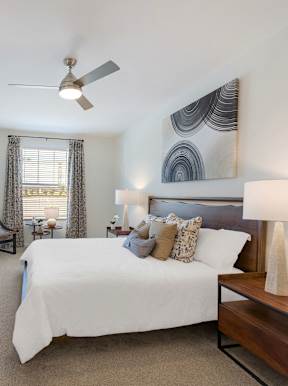 a living room filled with furniture and a large window