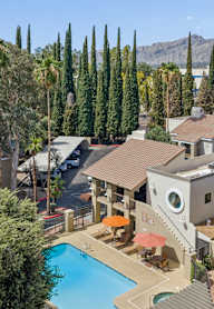 A swimming pool with a slide and sun loungers.