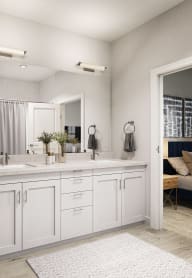 a white bathroom with a toilet and a sink and a mirror