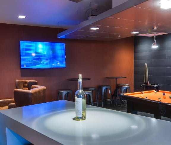 a room with a pool table and a tv