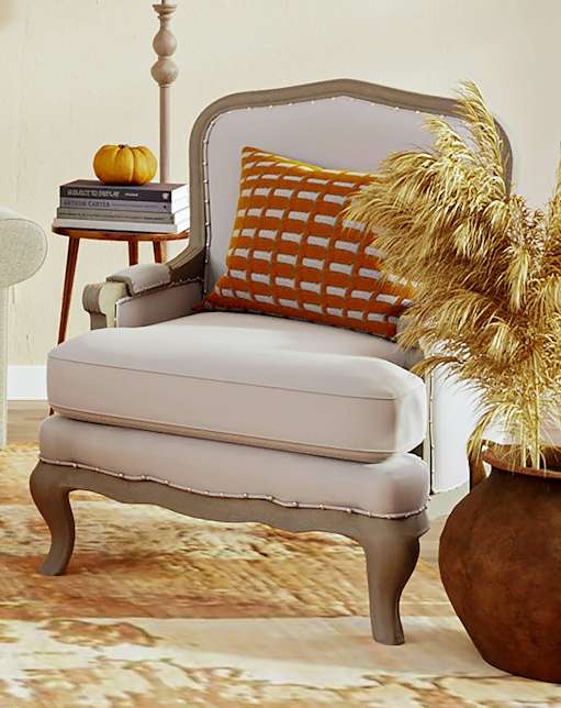 A living room with a sofa, armchair, and a coffee table.