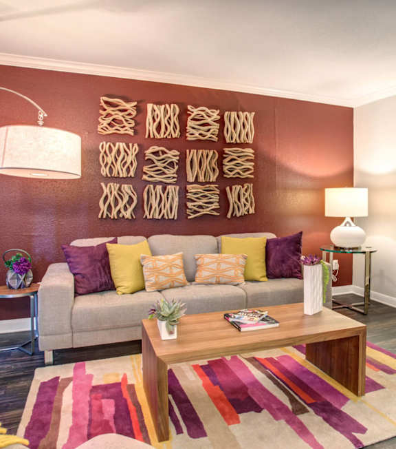 A living room with a couch, a coffee table, and a rug.
