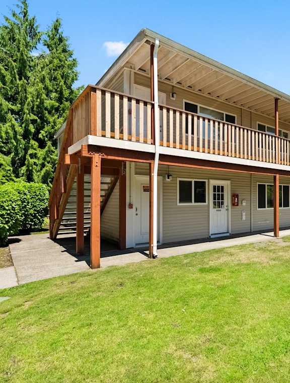 the outside of a building with a lawn and a porch