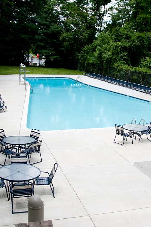 the swimming pool at the residence at dusk at Kenilworth at Charles Apartments, Towson, MD, 21204