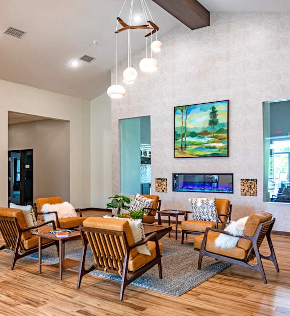 a living room with a table and chairs and a fireplace