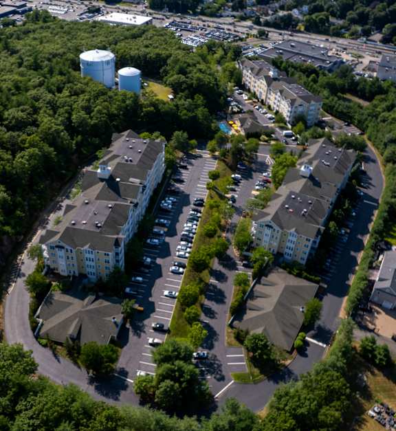 A bird's eye view of a residential area surrounded by trees.