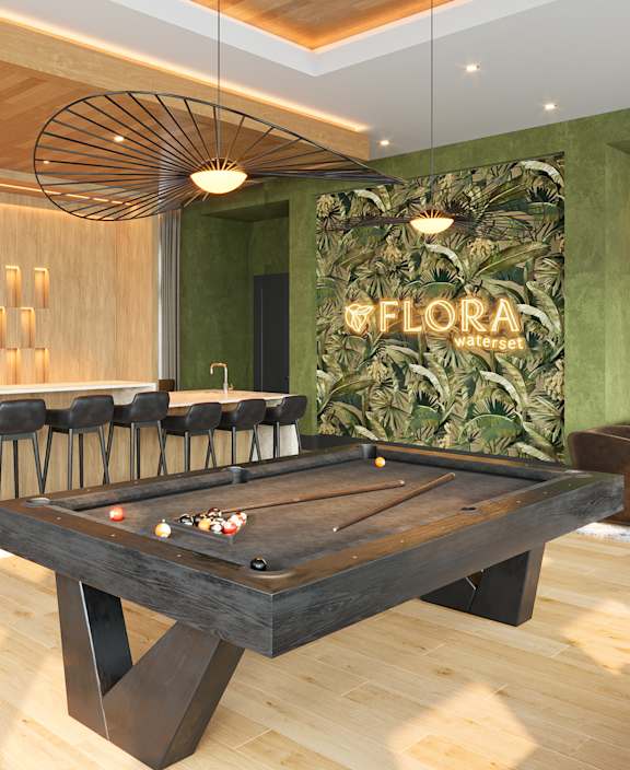 A pool table is in the middle of a room with a green wall and a sign that says "Clubroom Game Room".