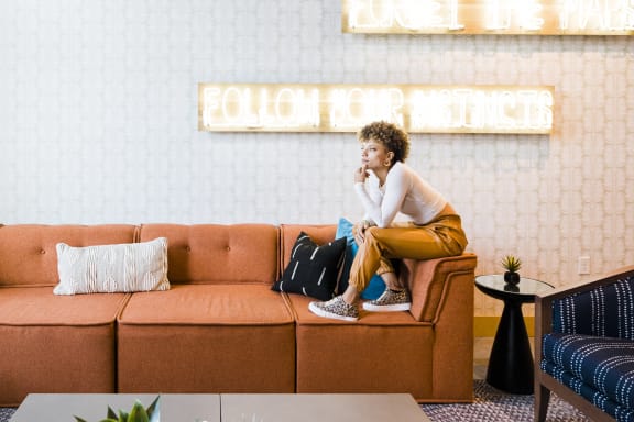 a woman sitting on a couch in a hotel lobby