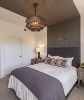 a bedroom with a large bed and a white table