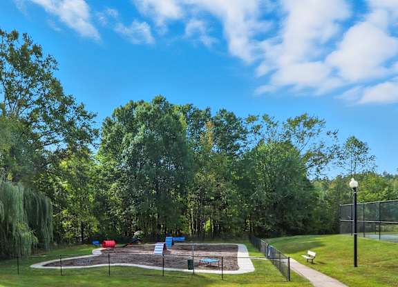 A park with a playground and a walking path.