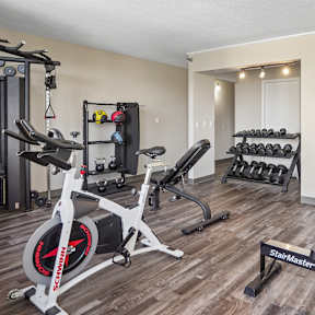 Fitness center with weights, stationary bike and exercise equipment at Irvine Park Towers