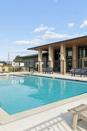 A dining room with white chairs and a table.