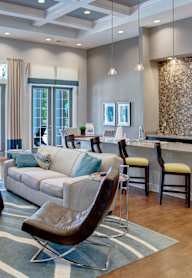 a living room filled with furniture and a large window